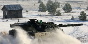 A German Bundeswehr Leopard tank drives through the snow in preparation for a Dutch-German military exercise.