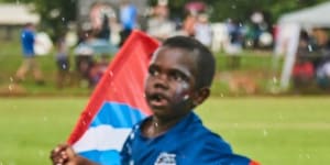 Young fans run on to the ground at the Tiwi Islands Football Grand Final.