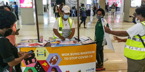 A stand distributes COVID-19 information at a shopping centre in Port Moresby.