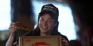 Wayne (Mike Myers) promotes Pizza Hut in a scene from Wayne’s World.