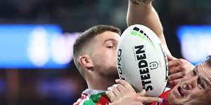 Brett Morris of the Roosters and Adam Doueihi of the Rabbitohs compete for the ball.