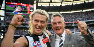 Darcy Moore and his father Peter celebrate the flag.