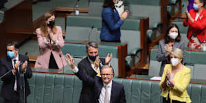 Opposition Leader Anthony Albanese waves to people in the public gallery after delivering the Budget reply speech.