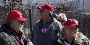 Supporters of former President Donald Trump,John Carson,of California,left,Karyn Carson,right,stand outside of security fencing around the US Capitol.
