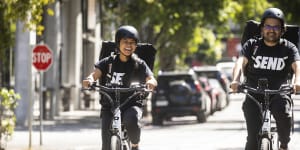 Delivery riders Mariella Bagang and Chintan Mewada work for Send in Melbourne. Unlike gig economy riders,they enjoy traditional employment.