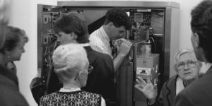Members of the Combined Pensioners’ and Superannuants’ Association wait while CityRail officers investigate a malfunction in one of the new ticket machines. April 24,1993.