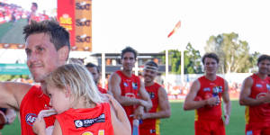 Gold Coast’s David Swallow leaves the ground victorious in his 200th AFL match for the club.