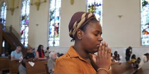 Marie Morette,a congregant of St Raphael Catholic church,prays during Mass in Springfield.