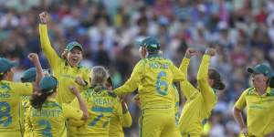 Australia players celebrate winning the gold medal in the cricket final at the Birmingham Commonwealth Games in 2022.