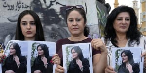 Kurdish women activists hold portraits of Iranian Mahsa Amini,during a protest against her death in Iran,at Martyrs’ Square in Beirut.