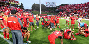 Dejected:Tonga players react after the final whistle.