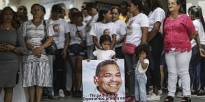 A girl holds a sign with the image of Luis Manuel Diaz,father of Colombian soccer star Luis Diaz.