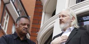 Julian Assange stands on the balcony of the embassy of Ecuador in London with Reverend Jesse Jackson. Embassy staff found him to be a difficult housemate.