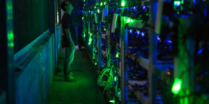 A manager checks equipment in a bitcoin mine in Sichuan,China.