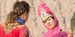 Women in Uighur costumes at the Flaming Mountains in Turpan,Xinjiang,last month.