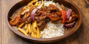 Lomo saltado,a Peruvian beef stir-fry,served with chips and rice.