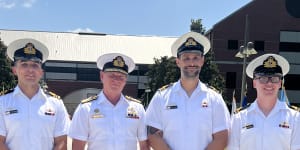 Nuclear power school graduates Lieutenant Commander James Heydon (left),Lieutenant Commander Adam Klyne (third from left) and Lieutenant William Hall (right) with Australian Navy chief Mark Hammond (second from left) 