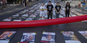 Families and friends of hostages held by Hamas in Gaza display 107 pictures of hostages as they protest outside the Prime Minister Benjamin Netanyahu’s residence in Jerusalem.