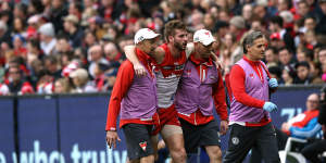 Alex Johnson is helped off the field after injuring his anterior cruciate ligament while playing for the Swans in 2018.