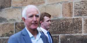 Darcy Clifton (right) leaves the Darlinghurst District Court with supporters.