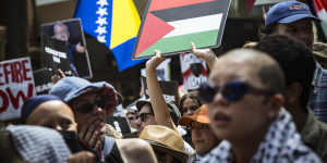 Protesters in Melbourne on Sunday brandish the Palestinian and Aboriginal flags.