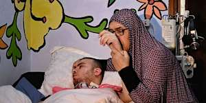 Najah al-Rajabi and her grandson Awad Nasser al-Rajabi in the family home in the Batn al-Hawa neighbourhood of Silwan,East Jerusalem.
