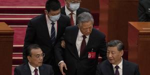 Former Chinese president Hu Jintao tries to talk to Premier Li Keqiang (left) and President Xi Jinping as he is escorted out of Congress.