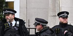 Police officers standing outside The London Clinic the day after Princess Catherine was admitted.