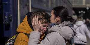 A mother embraces her son who escaped the besieged city of Mariupol and arrived at the train station in Lviv,western Ukraine on Sunday,March 20,2022. (AP Photo/Bernat Armangue)