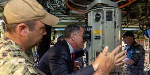 Deputy Prime Minister Richard Marles operates the periscope of submarine USS Asheville at HMAS Stirling in Western Australia. 