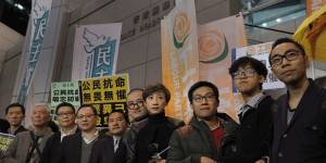 From right,former student leaders Eason Chung,Tommy Cheung,activist Raphael Wong,lawmakers,Tanya Chan,Shiu Ka-chun,former legislator Lee Wing-tat,founders of the Occupy Central civil disobedience movement,Benny Tai,Chan Kin-man and Chu Yiu-ming pose for a picture before walking toward a police station in Hong Kong on Monday.