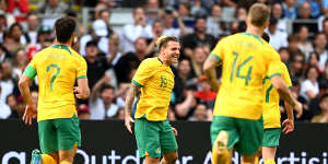 Jason Cummings celebrates a goal on debut for the Socceroos.
