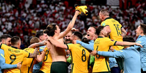 The Socceroos celebrate their penalty shootout win over Peru.