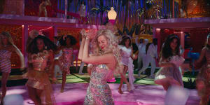 Margot Robbie as Barbie in her Dreamhouse where “every night is girls’ night!”