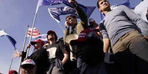 Right-wing podcaster Nick Fuentes (centre) speaks to Trump supporters at a rally in November 2020.