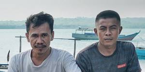 Trepang men Kasim (left) and Renaldy on a boat used to reach the Australian mainland. 