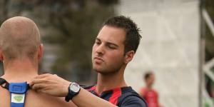 A Melbourne Demons player is fitted with a GPS unit.