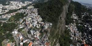 RIO DE JANEIRO,BRAZIL - JULY 04:Hillside'favela'communities stand in the foreground on July 4,2016 in Rio de Janeiro,Brazil. July 5 marks the one-month mark to the beginning of the Rio 2016 Olympic Games with an economic crisis,political turmoil and Zika virus fears roiling the country. (Photo by Mario Tama/Getty Images) Rio favelas