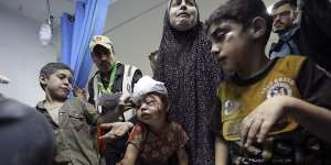 Wounded Palestinians arrive at the al-Shifa hospital,following Israeli airstrikes on Gaza City.