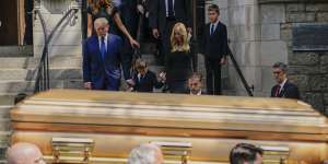 Former US president Donald Trump,far left,leads his family behind the gold-hued casket of his ex-wife Ivana at St Vincent Ferrer Roman Catholic Church in New York.