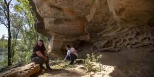 Gundungurra traditional owners Kazan Brown (left) and her daughter Taylor Clarke visit a rock shelter that will be inundated if the Warragamba dam wall is raised and the larger lake fills. The rock shelter has many signs of Indigenous habitation from stone tools to rock grooves used to sharpen them.