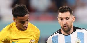 Keanu Baccus and Lionel Messi battle for possession at the World Cup.