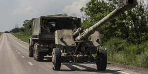 Ukrainian forces transport a 152 mm howitzer 2A65 Msta-B along a main road in the Donbas region of eastern Ukraine on June 12.