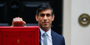 Chancellor of the Exchequer Rishi Sunak with the traditional red dispatch box containing his budget speech.
