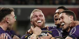 King (centre) celebrates with teammates after scoring a try in August.