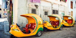 Cuba’s yellow Cocotaxis,designed to resemble a hollowed-out coconut.