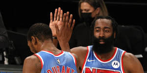 Double trouble:James Harden high-fives Kevin Durant in Harden's Nets debut.