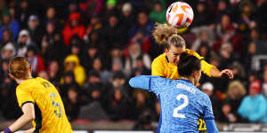 Australia’s Charlie Grant heads the ball past Lucy Bronze to score against England in April.
