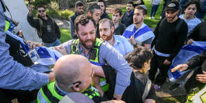 Counter-demonstrators clash with university security at Monash on Wednesday.