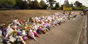 Flowers,plush toys and candles blanket the front lawn of Hillcrest Primary School in Devonport on Friday morning.